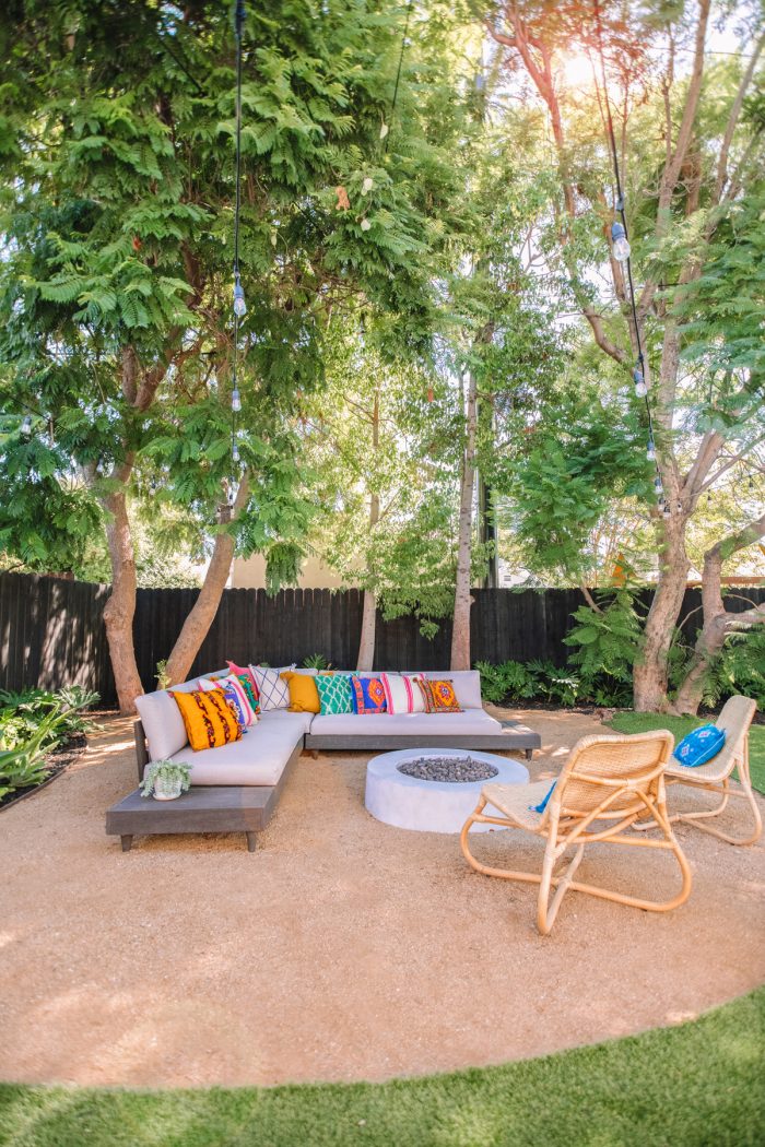 A fire pit with an outdoor couch and chairs