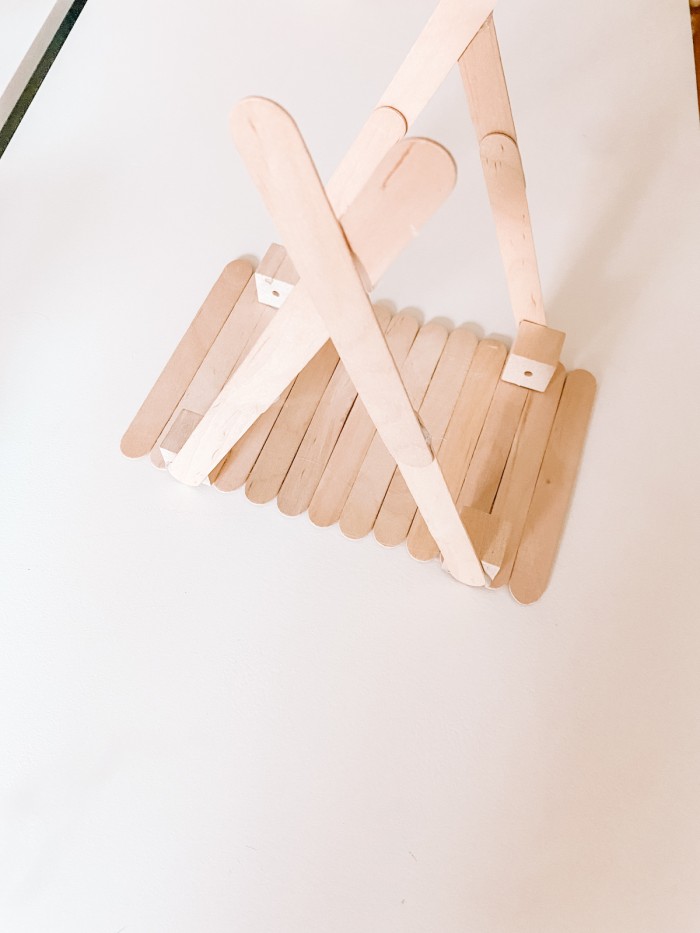 Popsicle sticks with wood blocks to make a brace