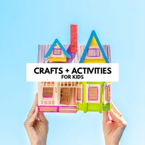 Popsicle stick house with text on top