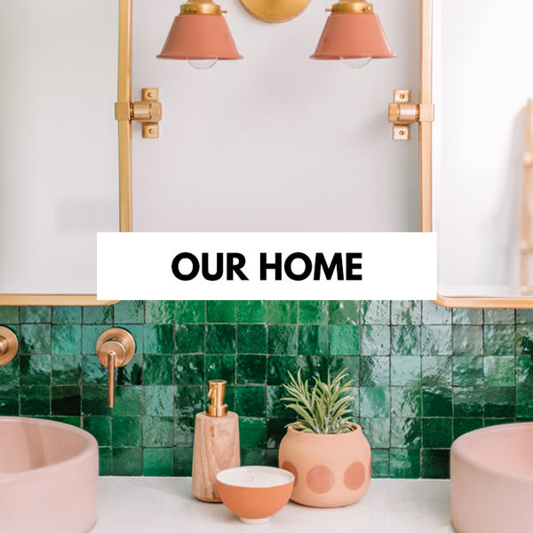 A room with a sink and a mirror with our home written on top