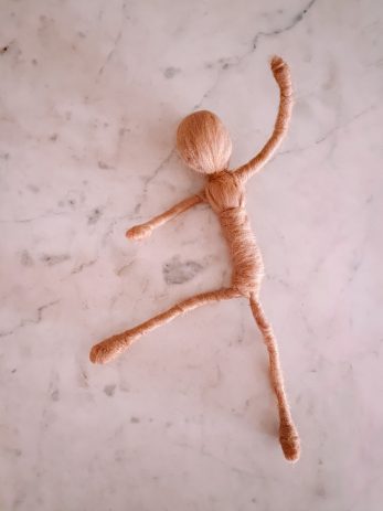 A doll made with yarn wrapped around wire
