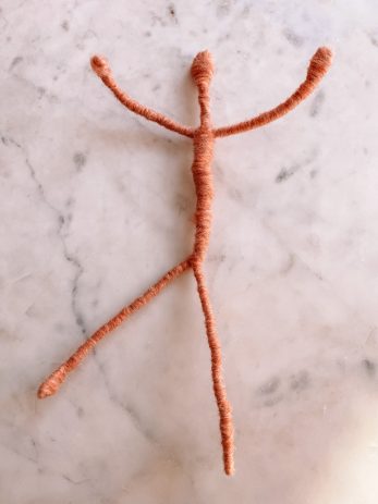 Yarn wrapped around a wire in a body shape