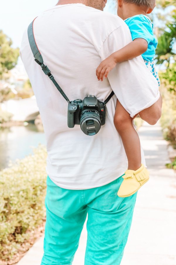 A man with a camera around him