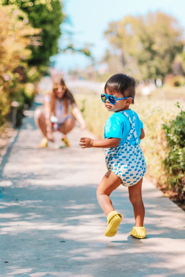 A little boy walking down a path