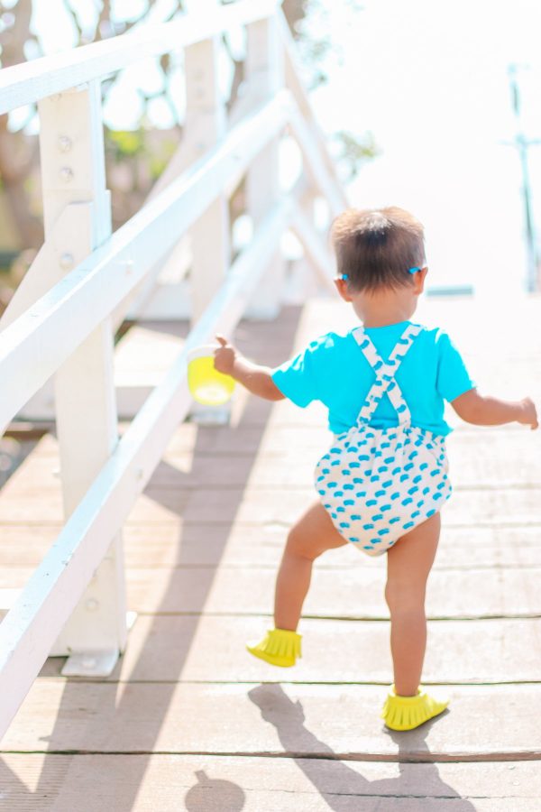A boy walking down a boardwalk