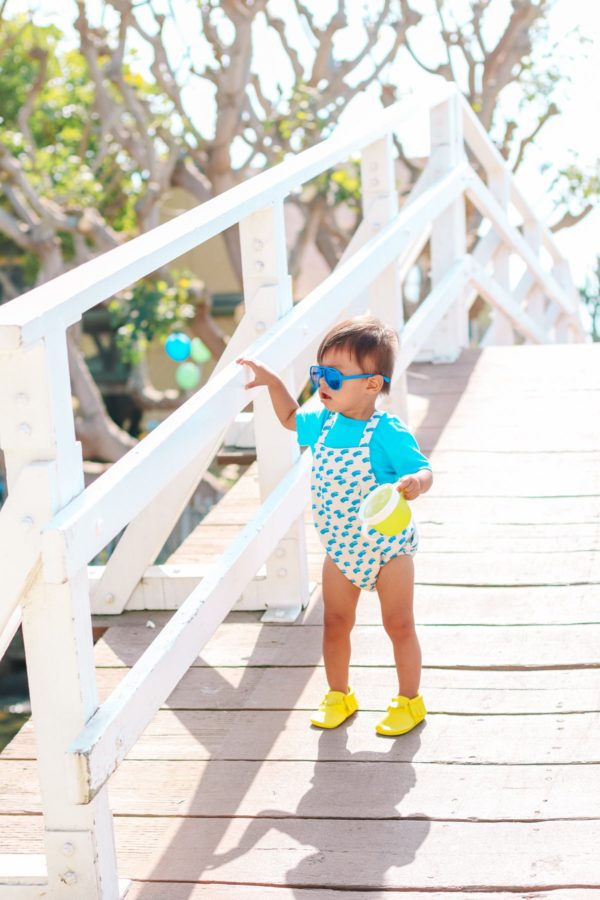 A little boy walking down a wooden path