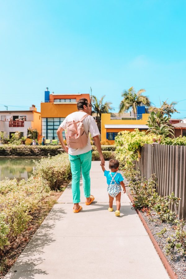 A man and a little boy walking down a path