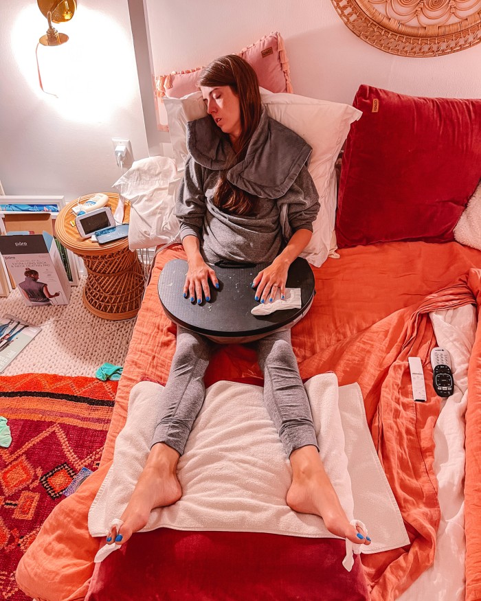 Woman asleep in pink bed