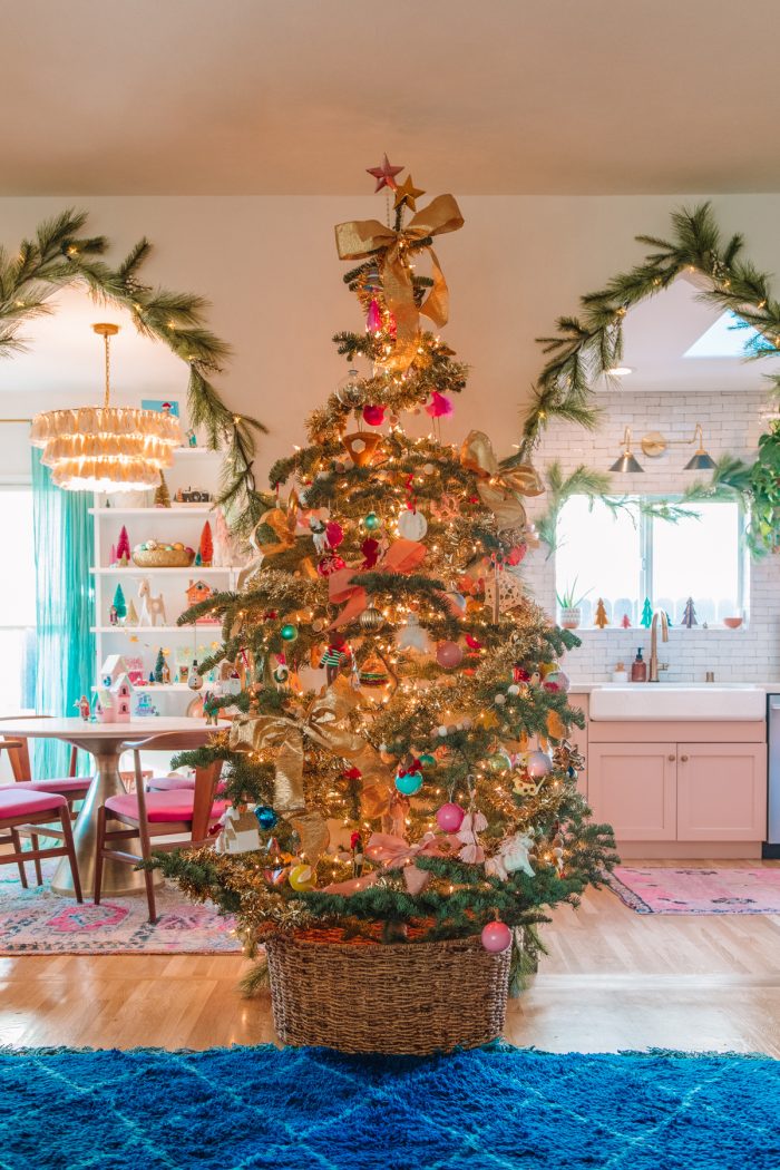 Photo of a living room with a Christmas tree and more Christmas decorations around the house. 